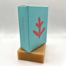 Load image into Gallery viewer, Bar soap with blue packaging called 'Spruce + Rose'
