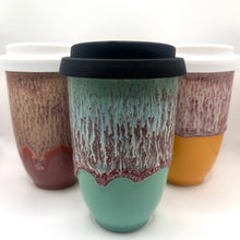 Load image into Gallery viewer, Ceramic Travel Mugs with black and white tops and dripping blue, orange, red and white design
