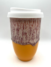 Load image into Gallery viewer, A ceramic travel mug with a white lid and a swirled orange and red design.
