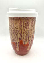Load image into Gallery viewer, A ceramic travel mug with a white lid, featuring a swirled amber and purple design.
